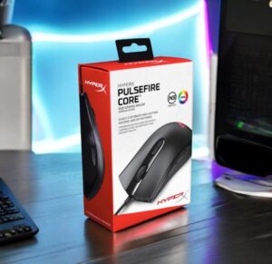 HyperX Pulsefire Core RGB Gaming Mouse retail box on desk setup with RGB background