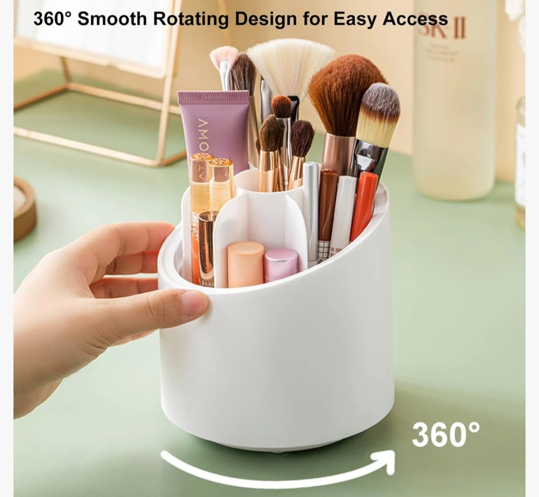A hand lifting a clear dustproof lid off a white 360-degree rotating makeup brush organizer filled with various cosmetic brushes and lipsticks.